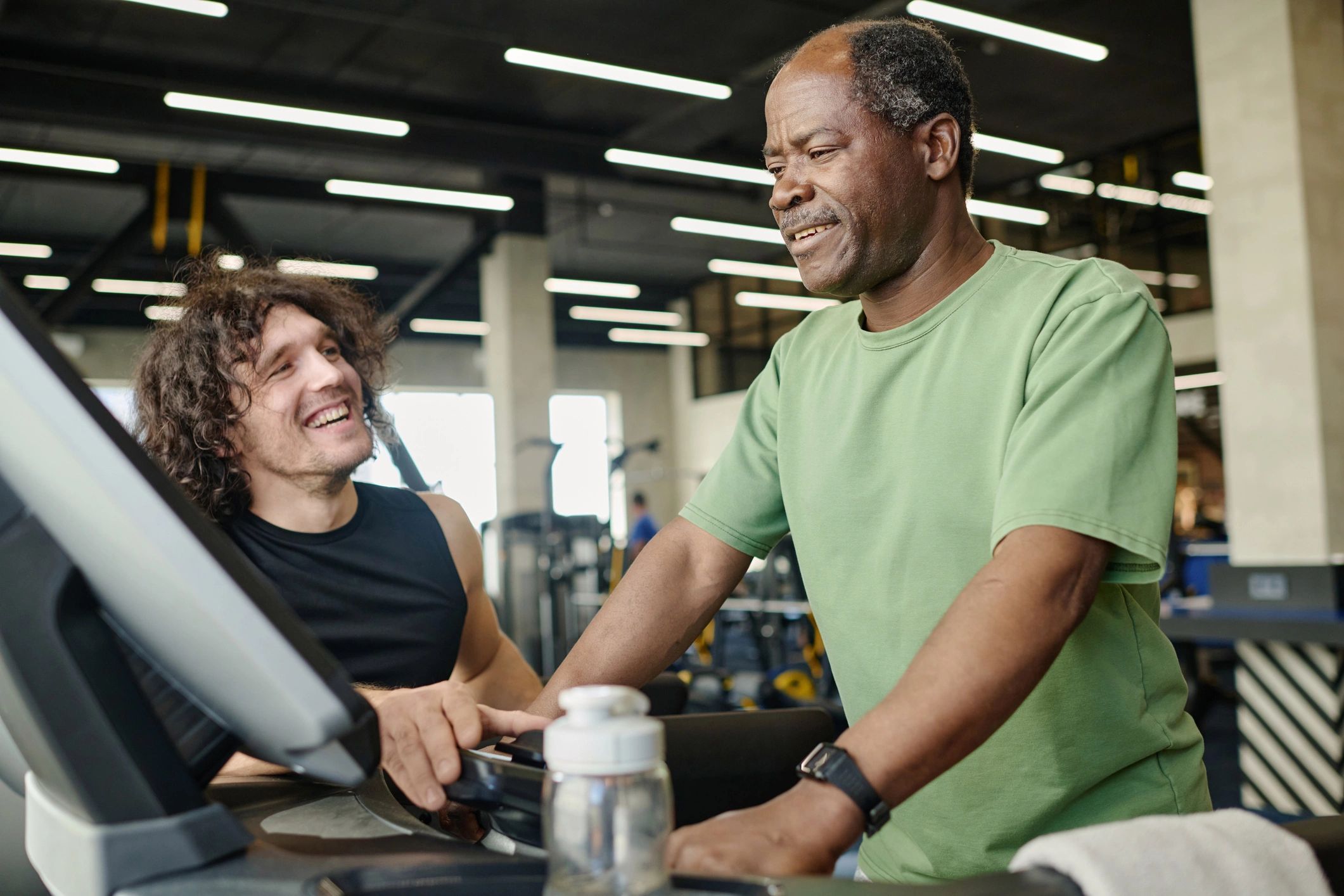 Trainer coaching a client during a treadmill workout