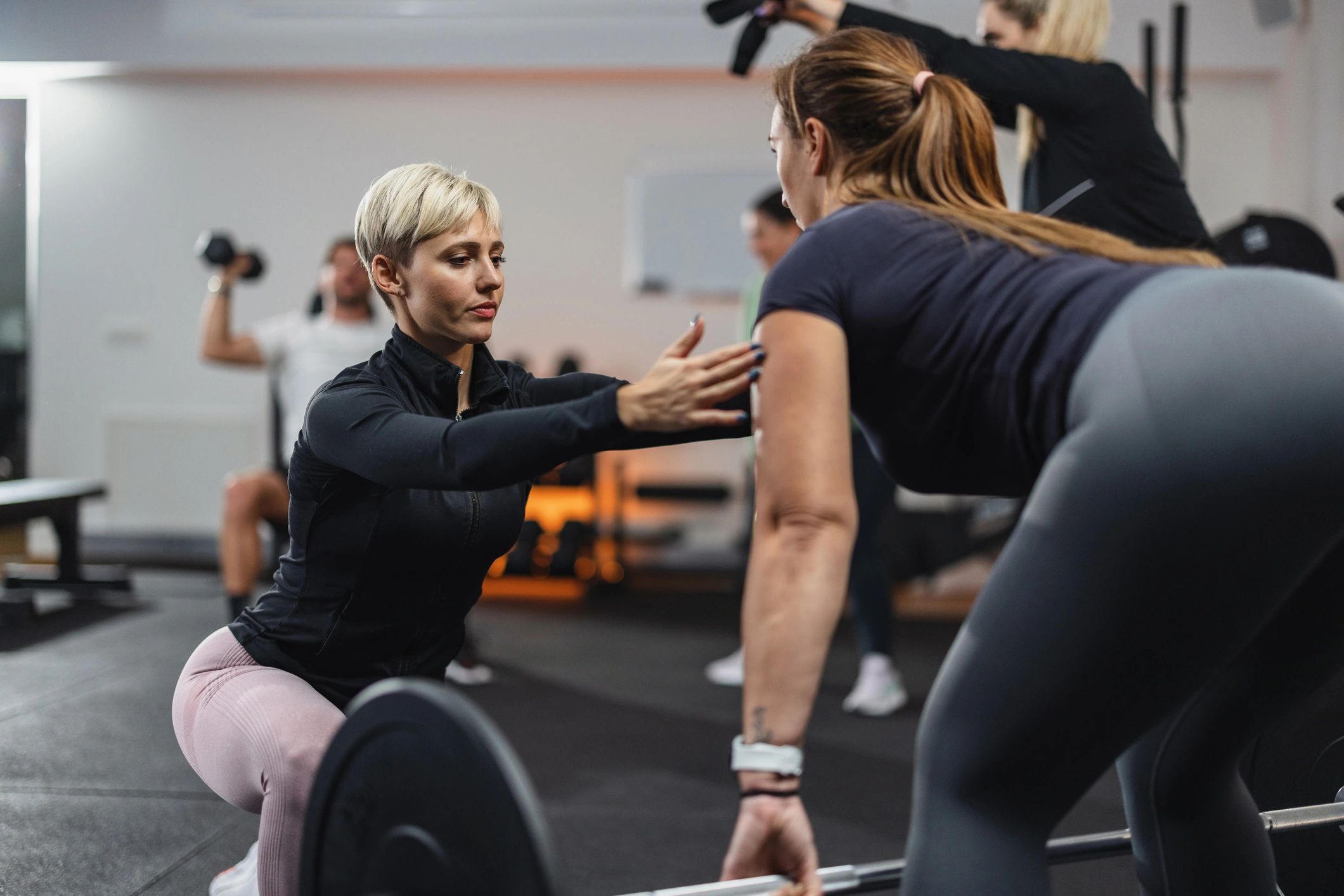 Fitness trainer coaching a client in a gym